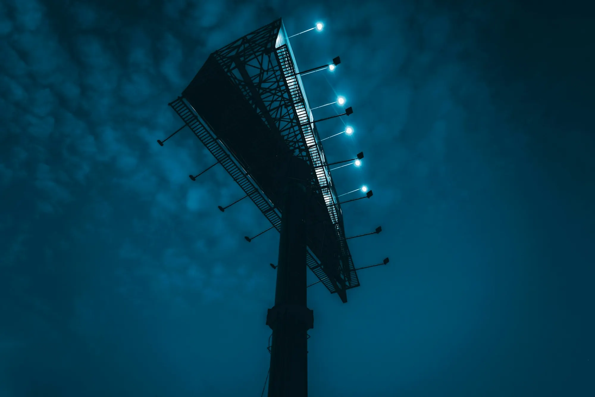 Billboard steel structure and catwalk against a night sky