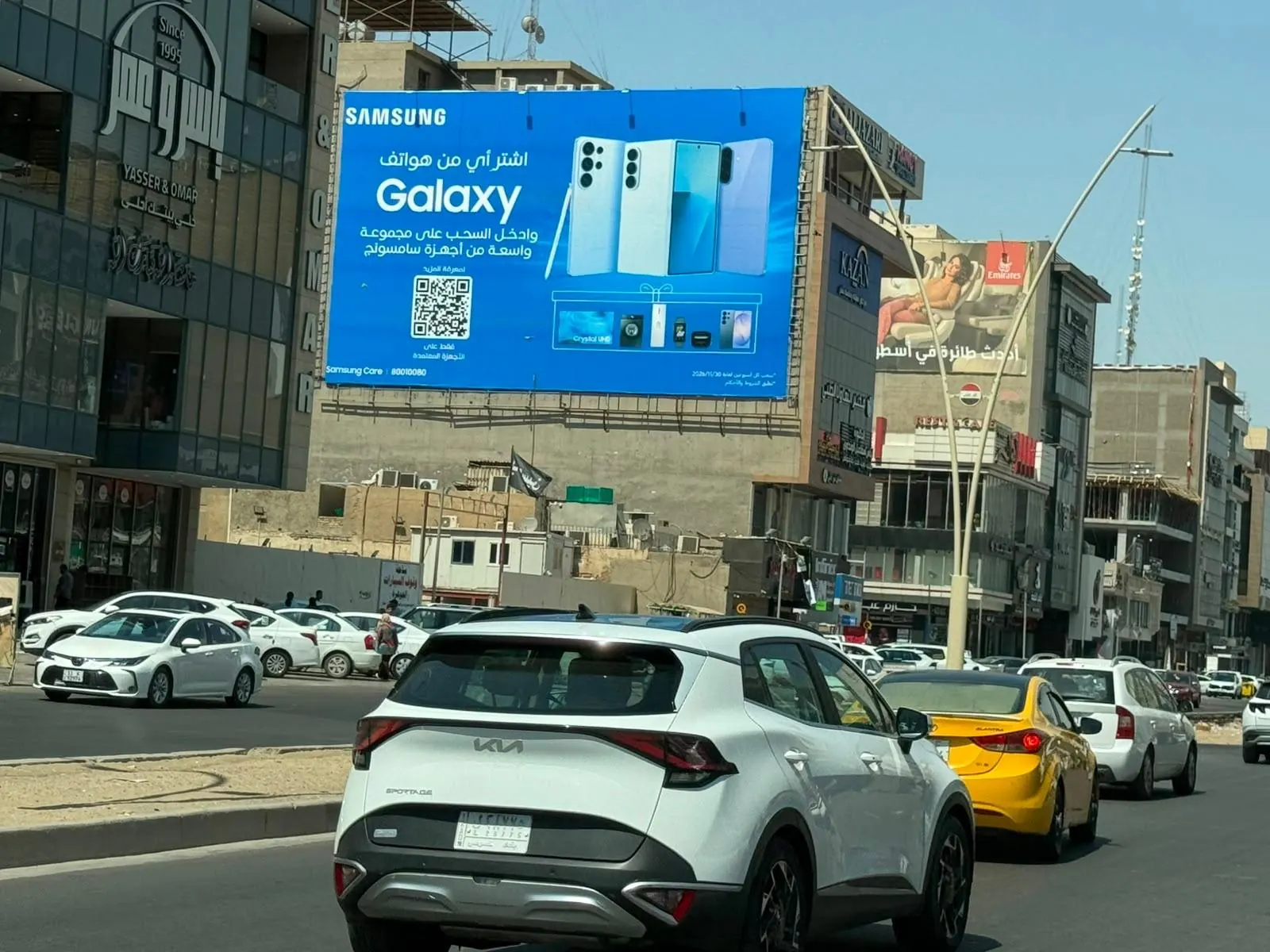 Samsung Galaxy campaign on a large billboard over a Baghdad street
