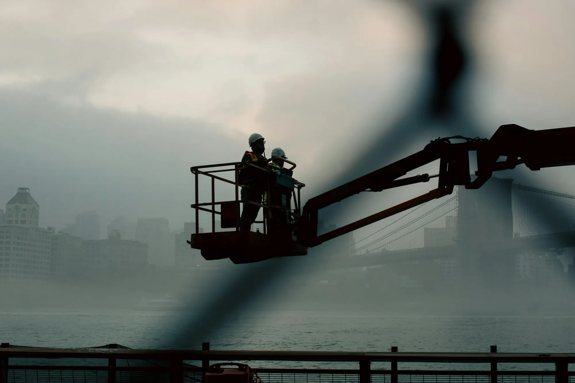 Two installers working from a boom lift at height