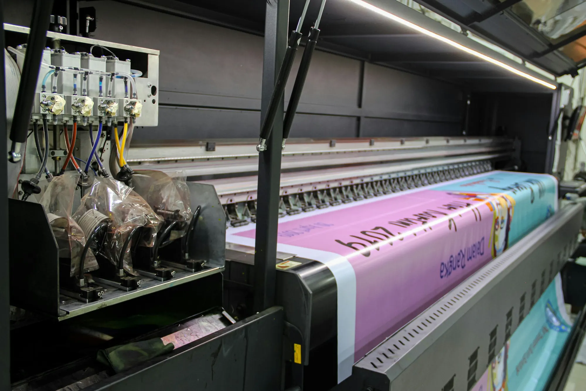 Wide-format printer printing a large vinyl banner